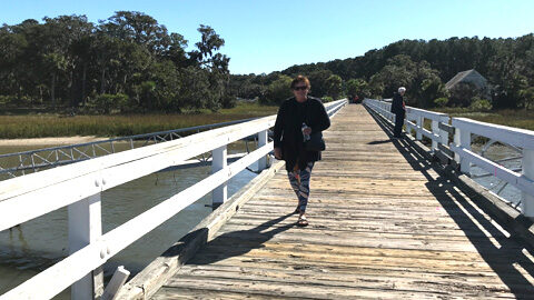 Docking on Daufuskie. woman walks down wooden dock