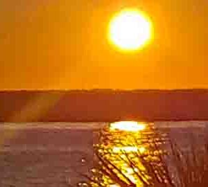 a sunset over the water.