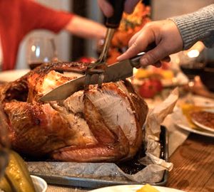 Give Thanks on Daufuskie. somone carving a turkey
