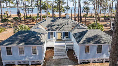 The Daufuskie Oasis. an aerial view of a blue house near the water